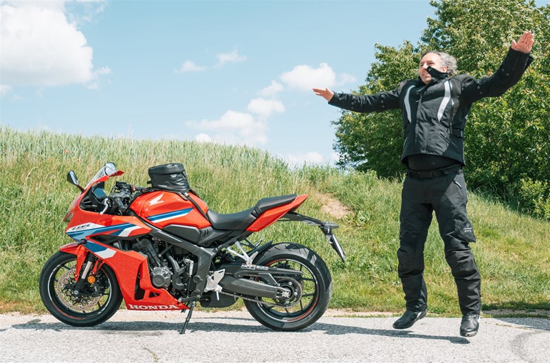 Motorradfahren lernen - Ein Hampelmann in der Pause während einer Motoradtour neben einer Honda CBR650R E-Clutch Motorradfahren lernen - Ein Hampelmann in der Pause während einer Motoradtour neben einer Honda CBR650R E-Clutch